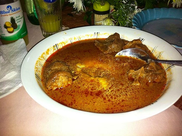 Fufu in a light tomato soup with goat. By sshreeves (Creative Commons)