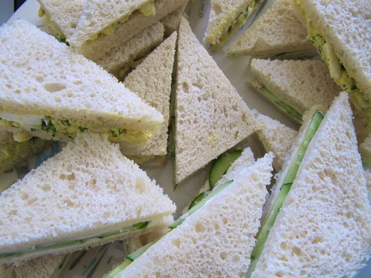 Delicately cut cucumber sandwiches. By portmanteaus (Flickr)