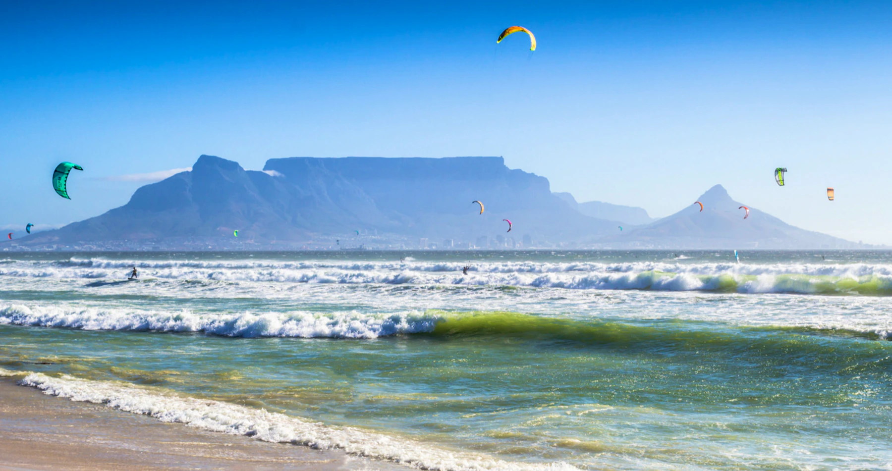 Kitesurfers on the Blouberg coast with Table Mountain behind