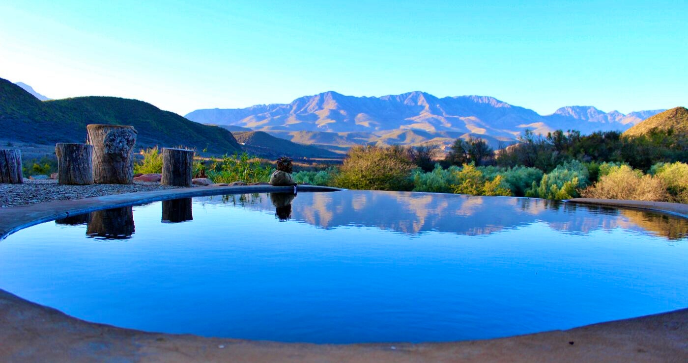 The private, flower-filtered pool offers a view of the mountains. 