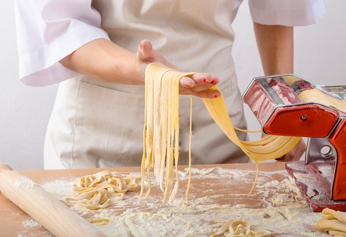 Young Woman Chef Prepares Homemade Pasta